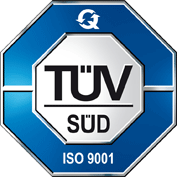 Logo TÜV SÜD con bordo ottagonale blu e argento, centro bianco e scritta 