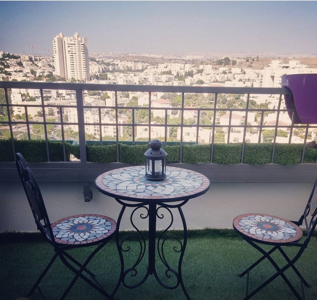 שולחן וכיסאות במרפסת המשקיפה על עיר
