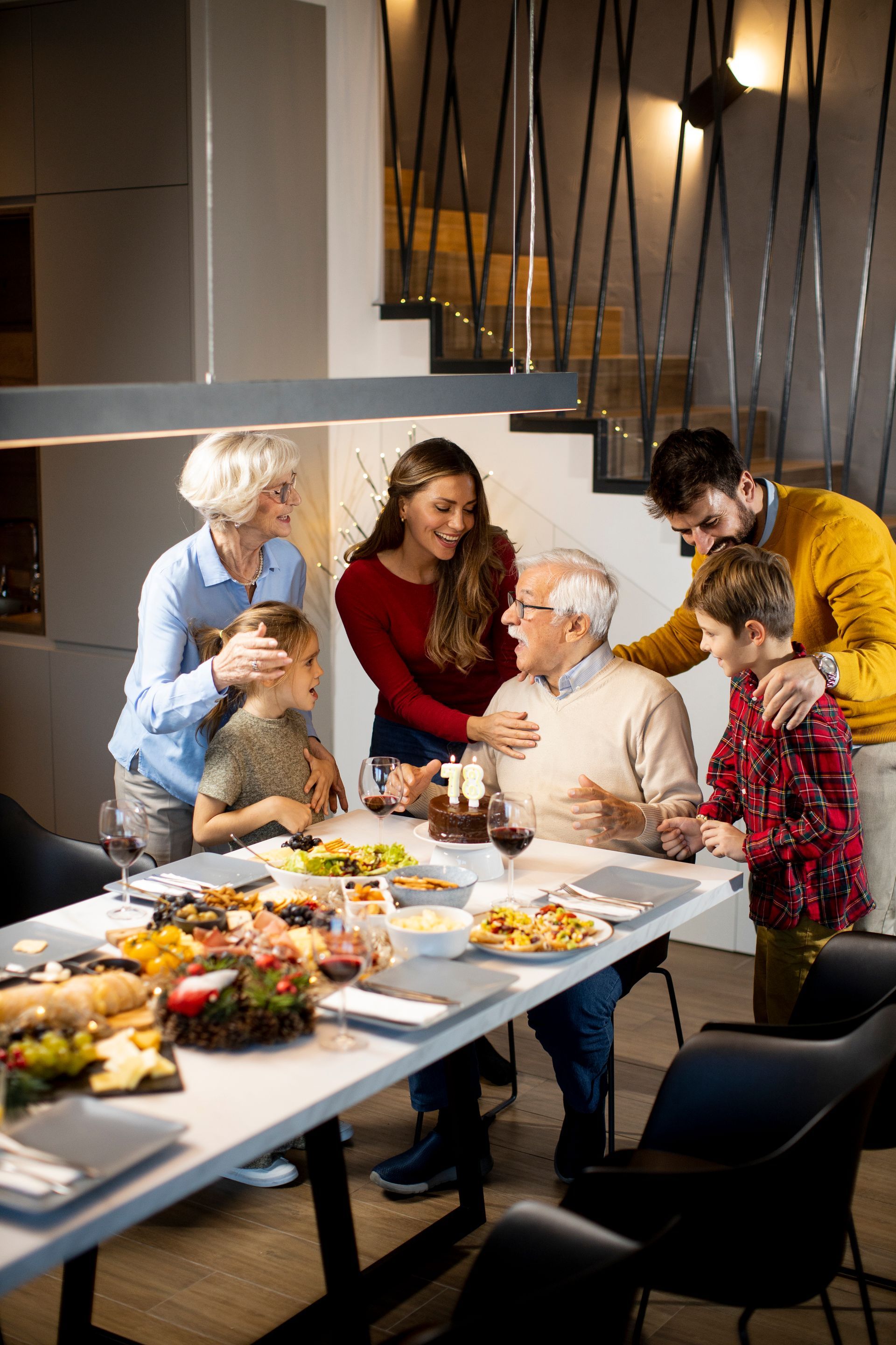 People gathered around a dining table sharing a meal in a modern home
