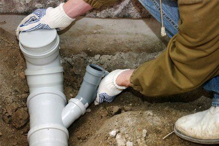 Plumber assembling pvc sewage pipes