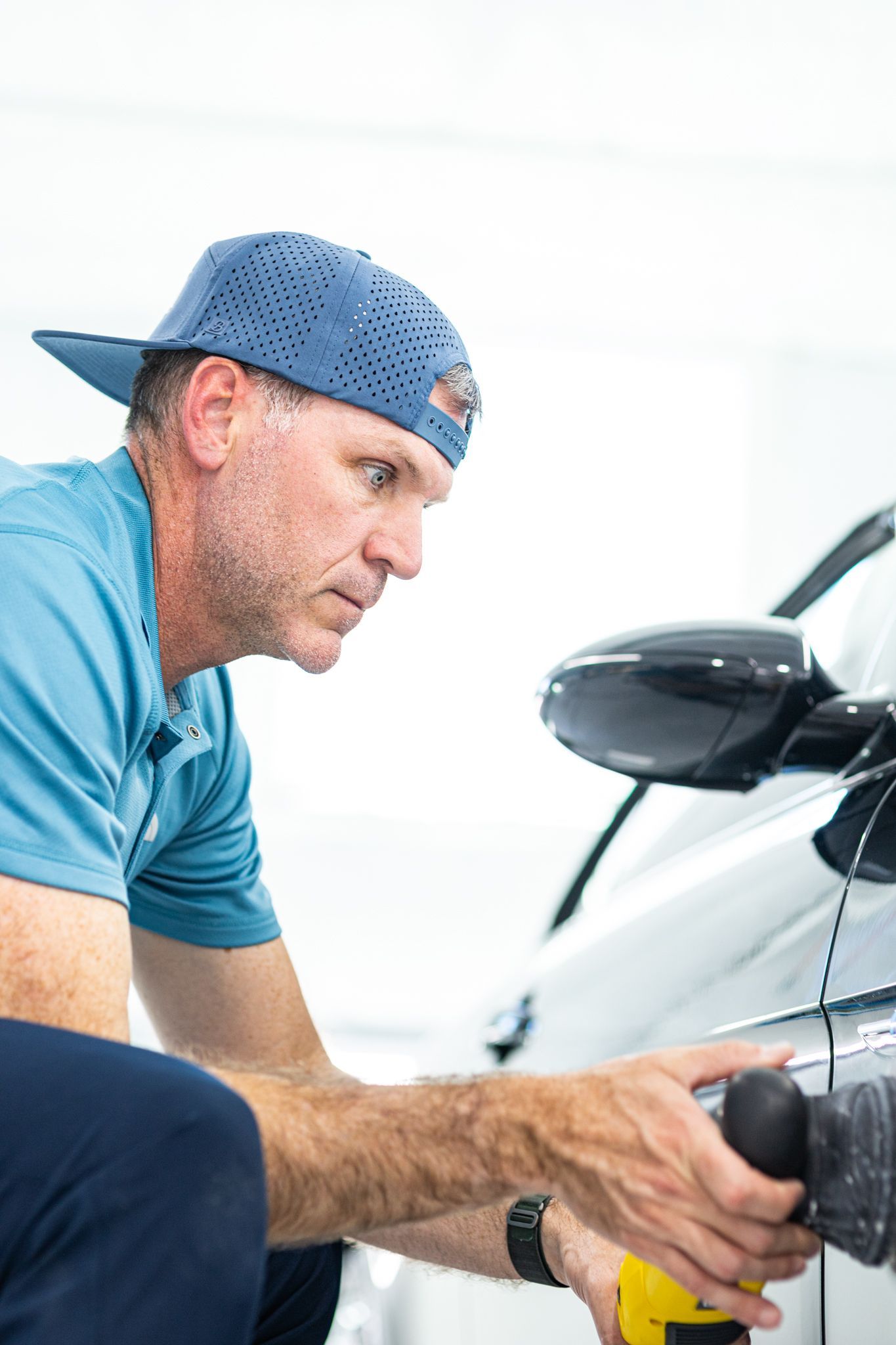 Integrity Auto Detail expert polishing car paint with rotary polisher in St. Louis