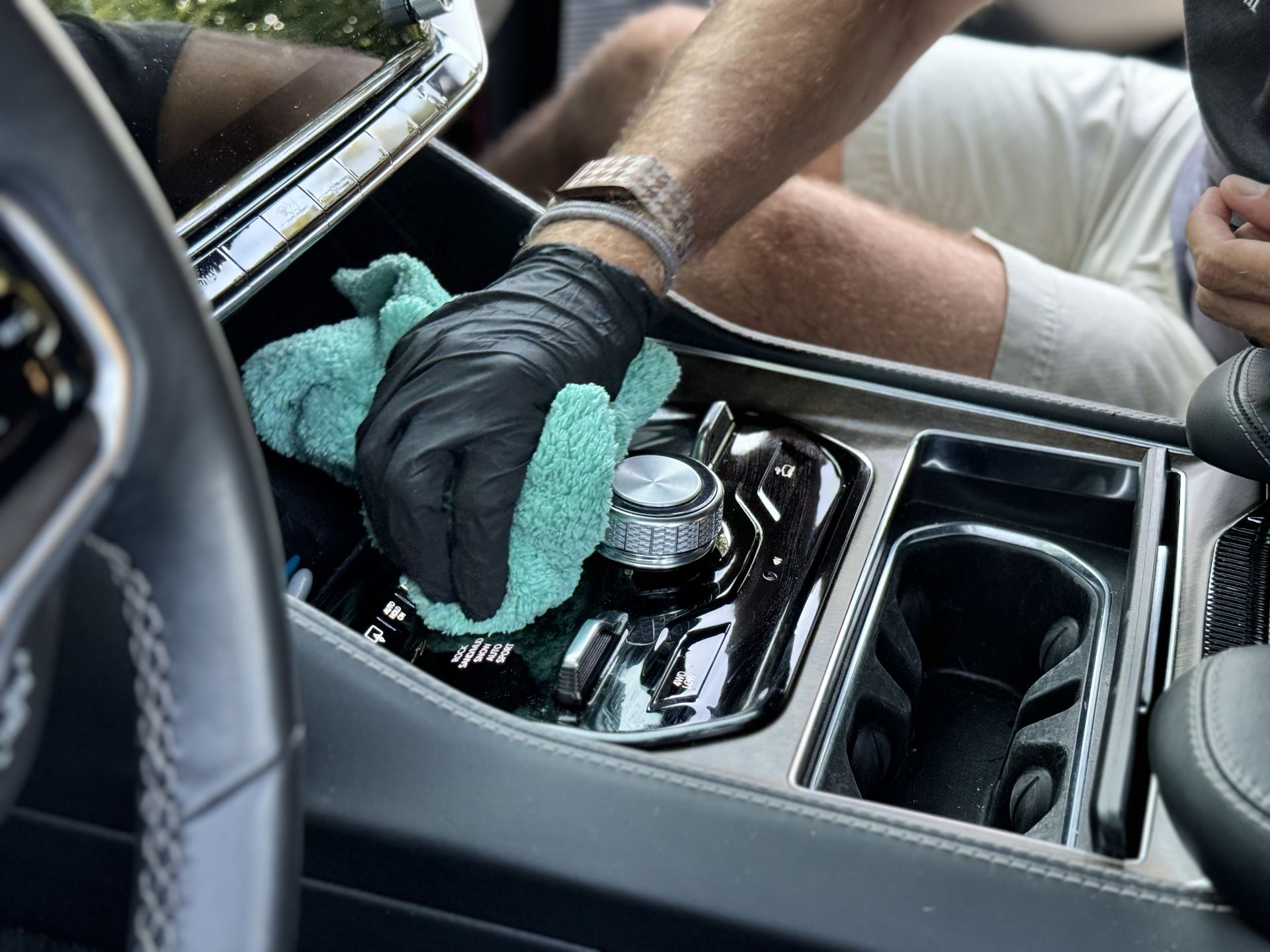 A person is applying a protective film to a car.