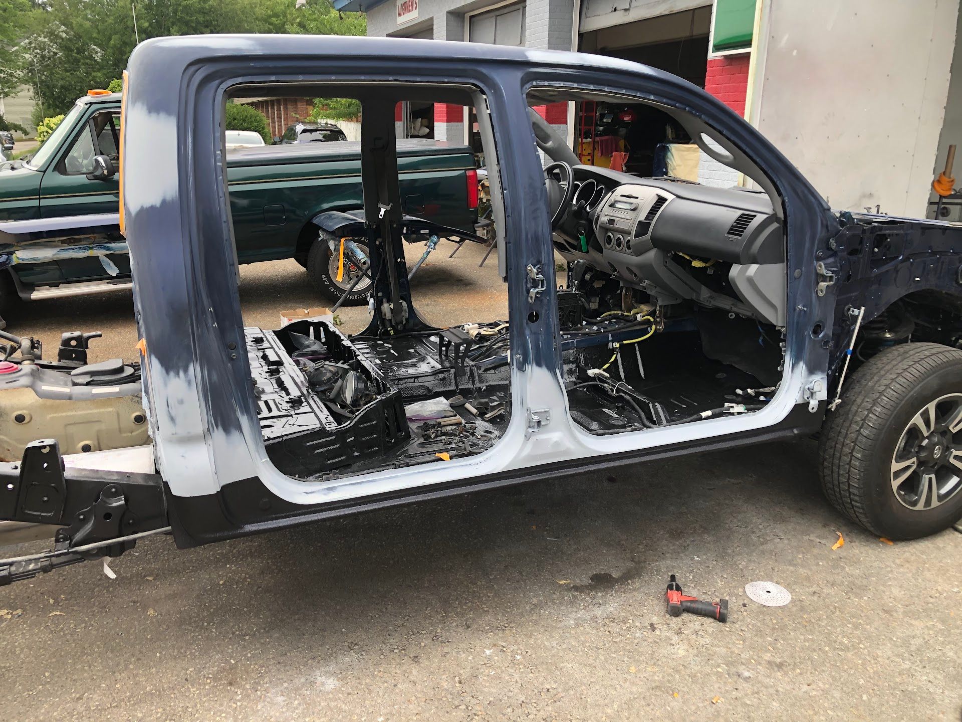Blue truck cab undergoing repair work; interior exposed, with tools nearby. | Rose Brothers Garage