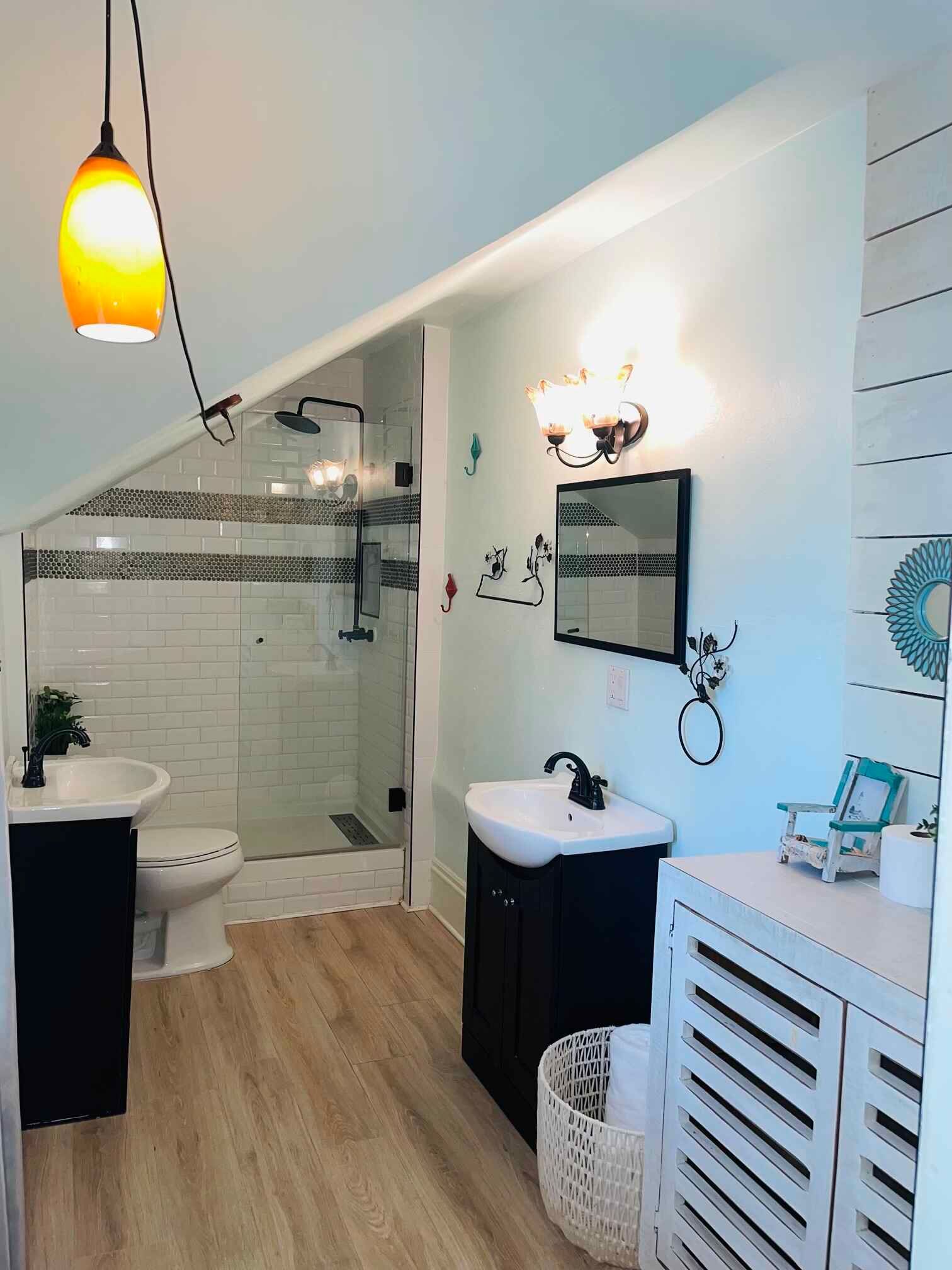 A bathroom with a sink , toilet , and shower.