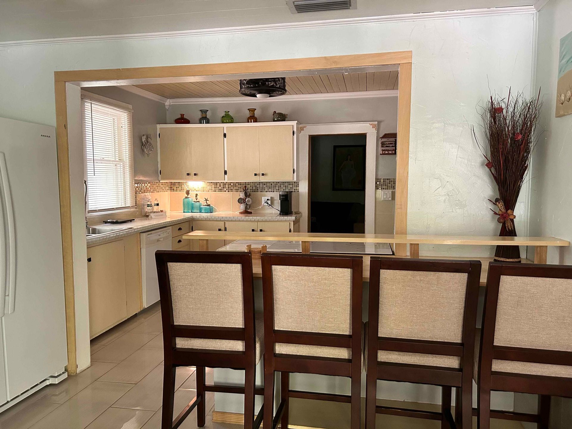 A kitchen with a table and chairs and a refrigerator