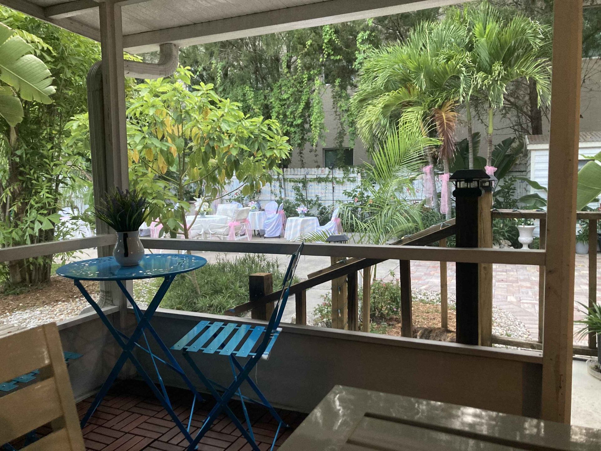 There is a table and chairs on the porch.