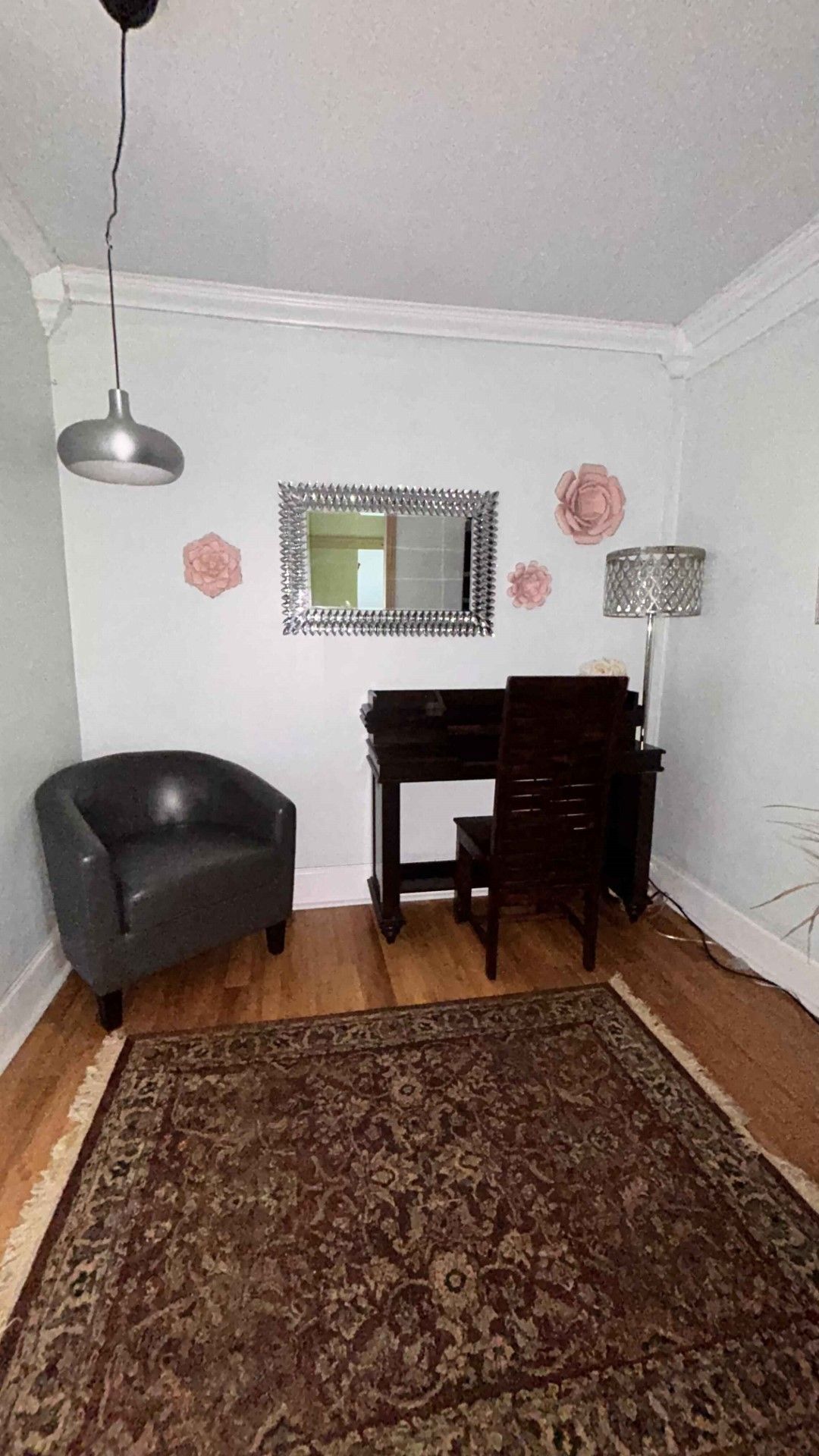 There is a chair and a desk in the room.