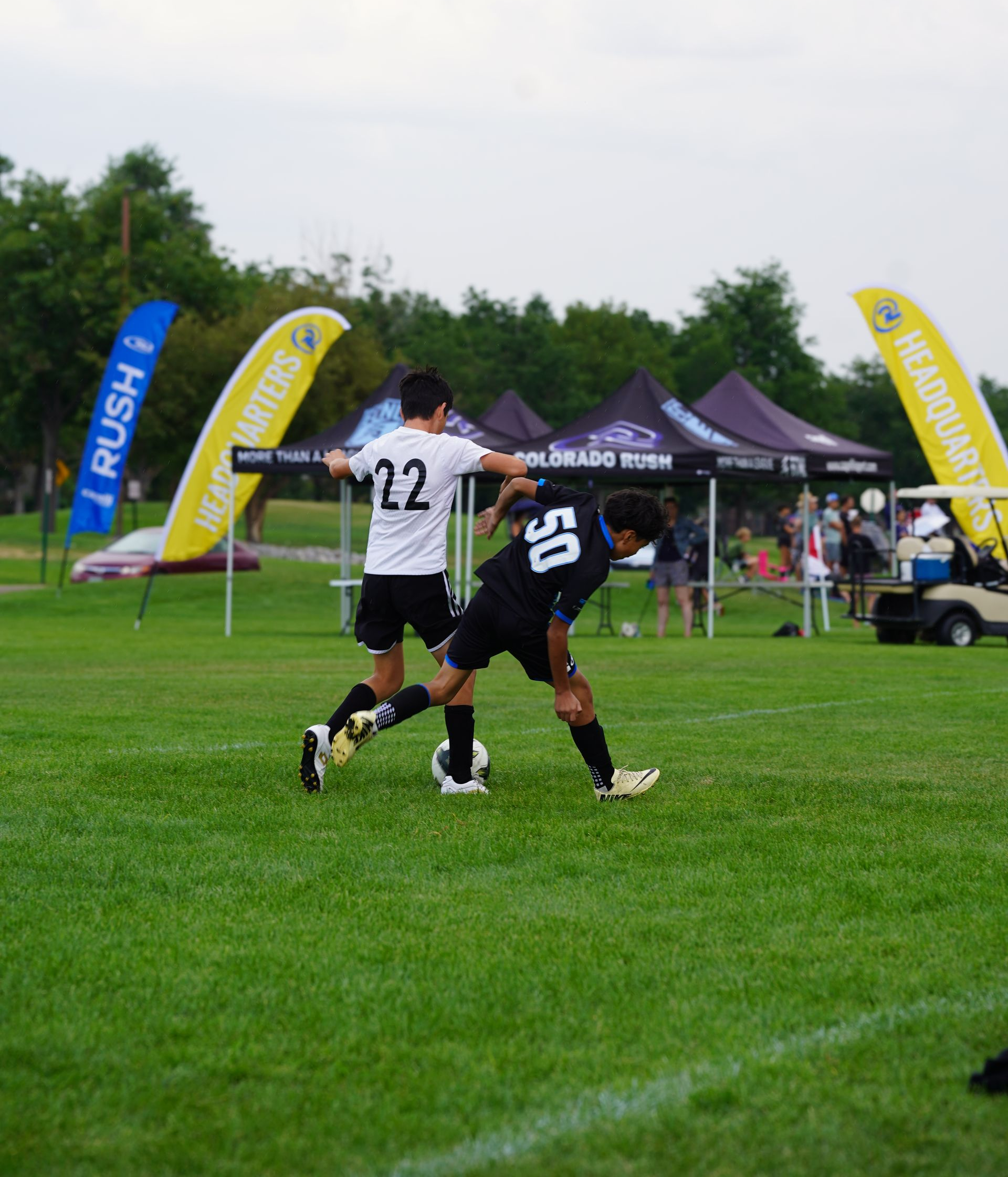 Two soccer players are playing on a field and one has the number 16 on his jersey