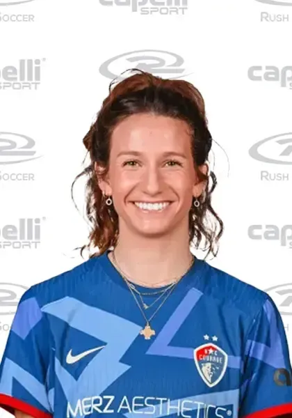 A woman is wearing a blue jersey that says merz aesthetics