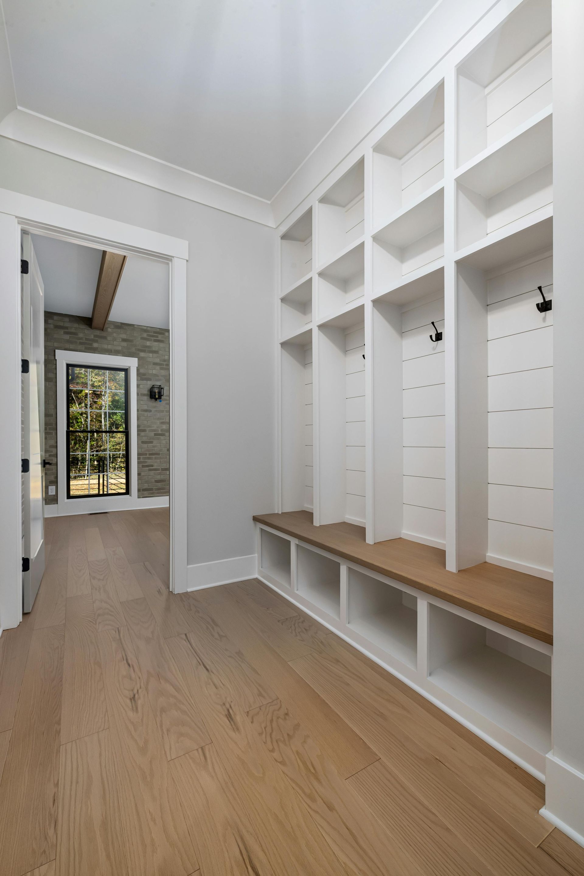 A room with a lot of shelves and a bench in it.