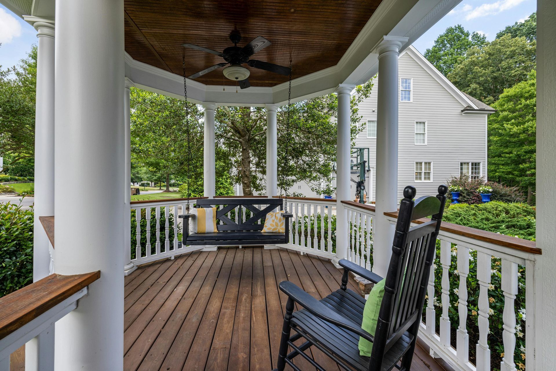 A porch with a rocking chair and a swing.