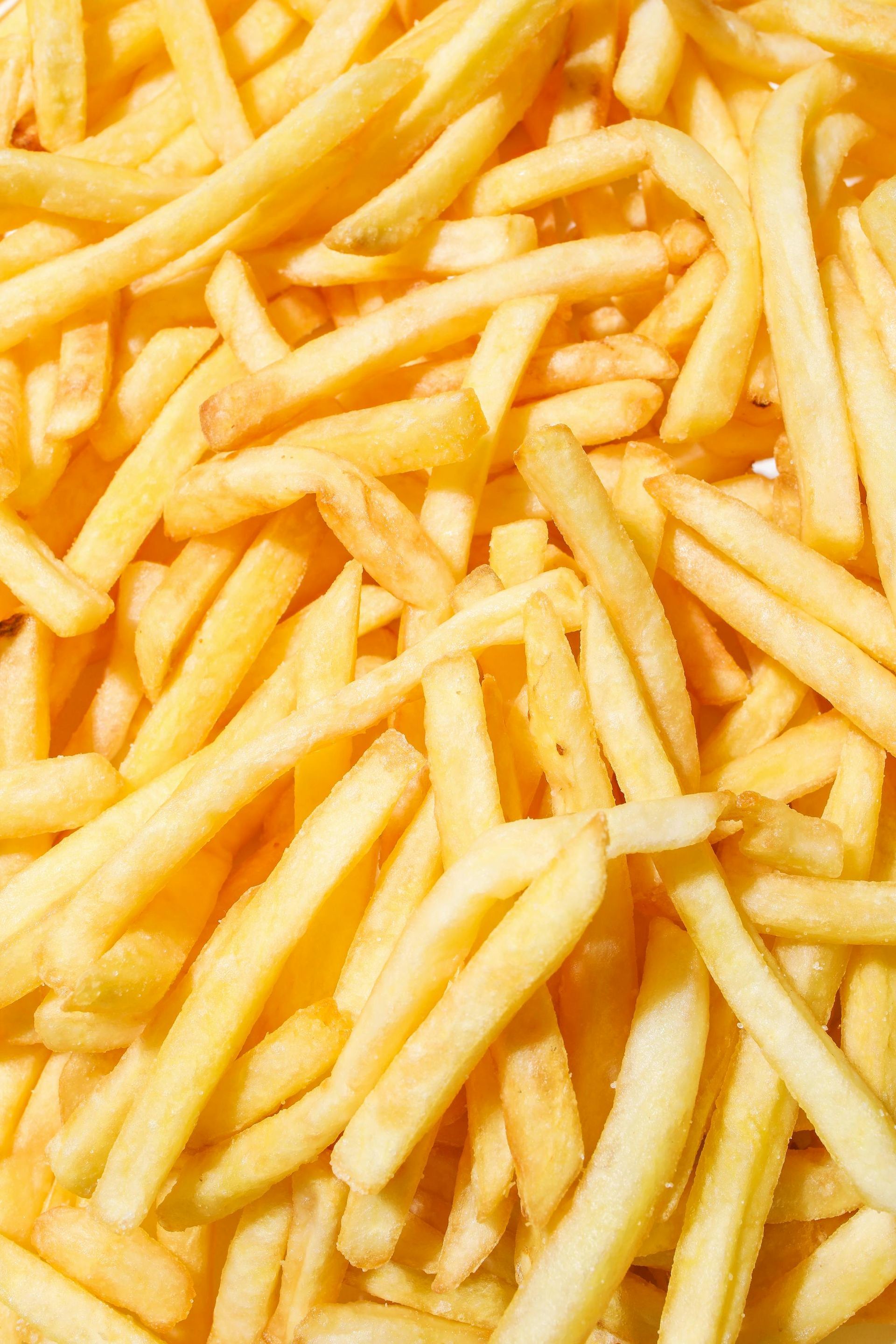 Golden fried potatoes in a close-up, textured pile.