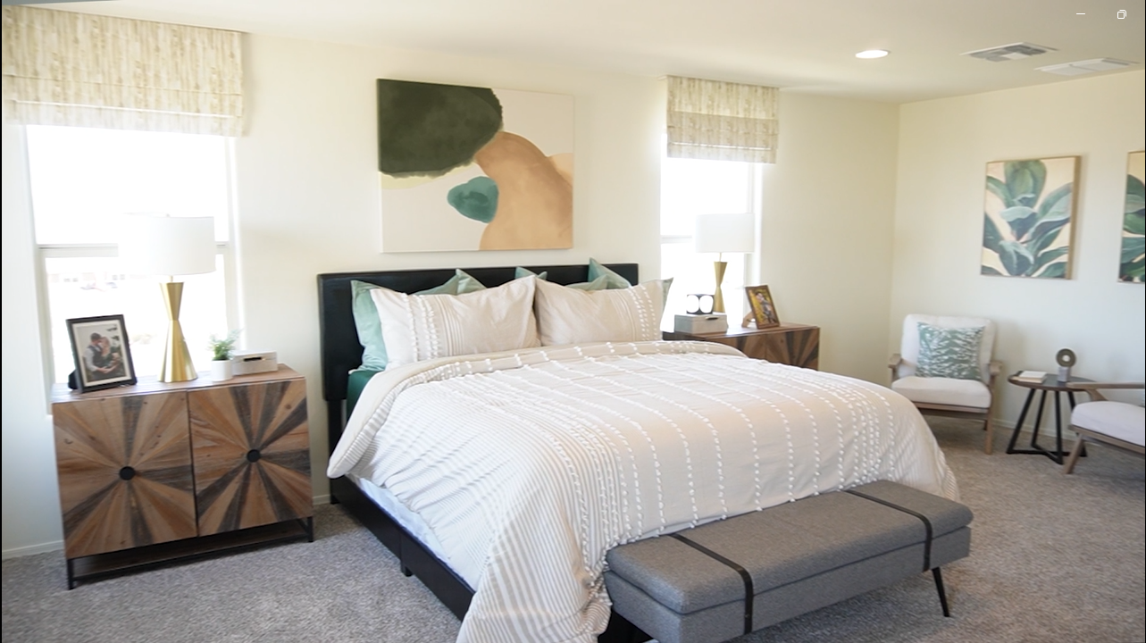 Inside Meritage Homes' Vineyard Floor Plan in Sahuarita - a spacious bedroom with a luxurious king bed.
