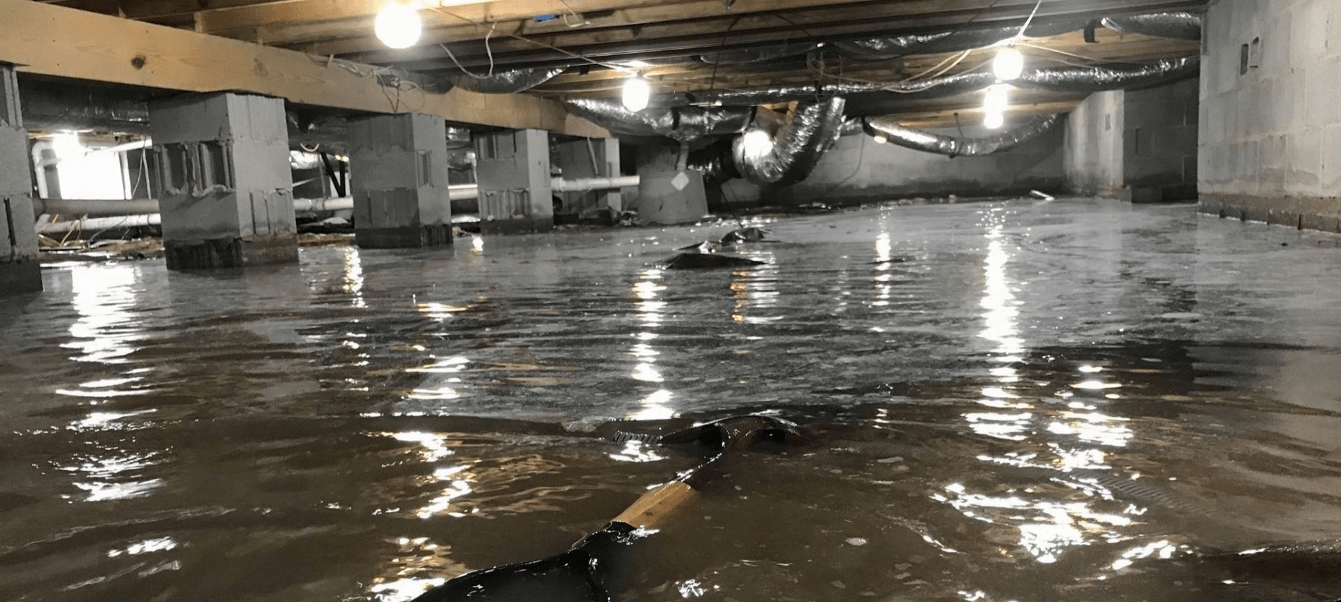 A flooded basement with a lot of water in it.