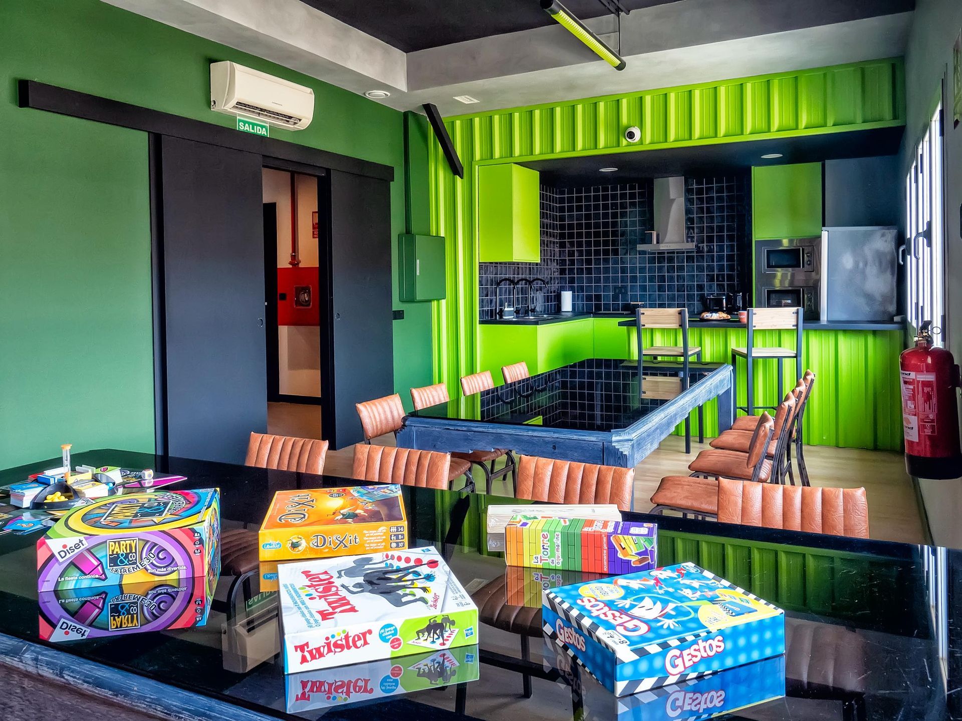 A room with a table and chairs and a bunch of games on it.