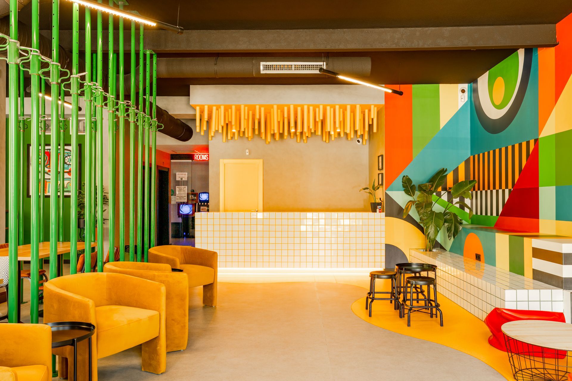 A room with a colorful mural on the wall and a counter.