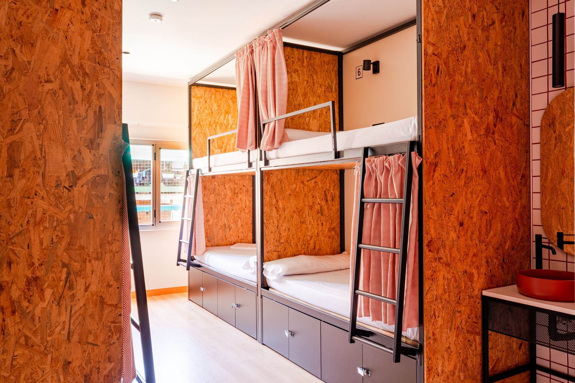 A room with bunk beds and a sink in it