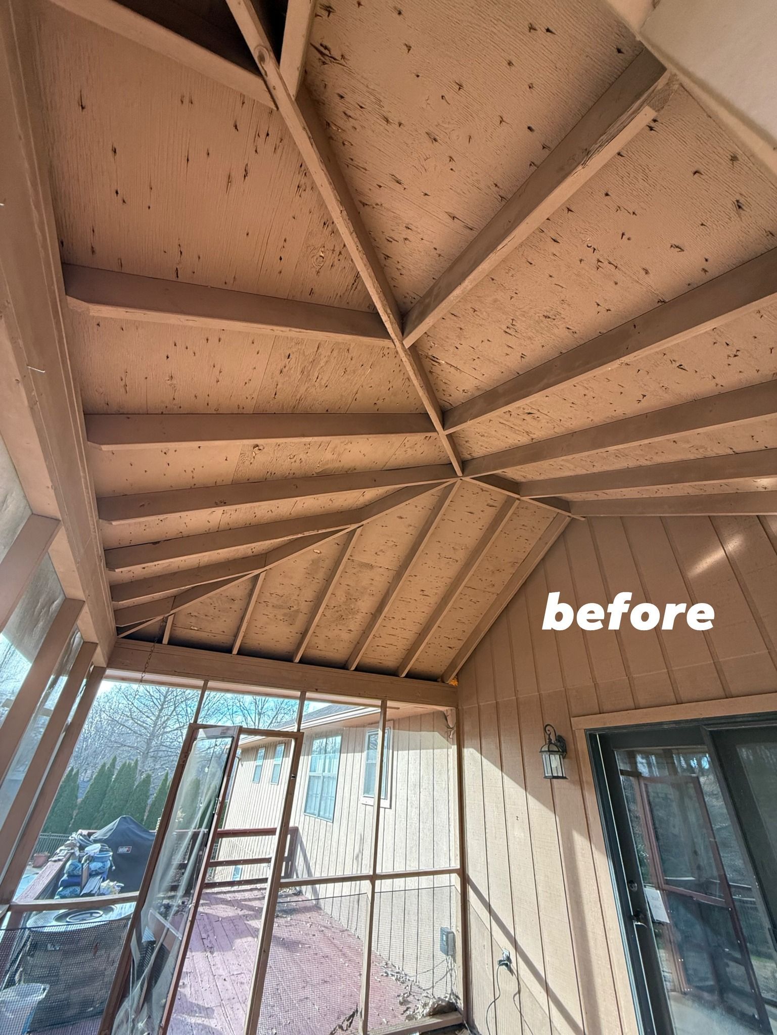 A view of an unfinished, exposed wooden porch ceiling and wall frame, labeled 