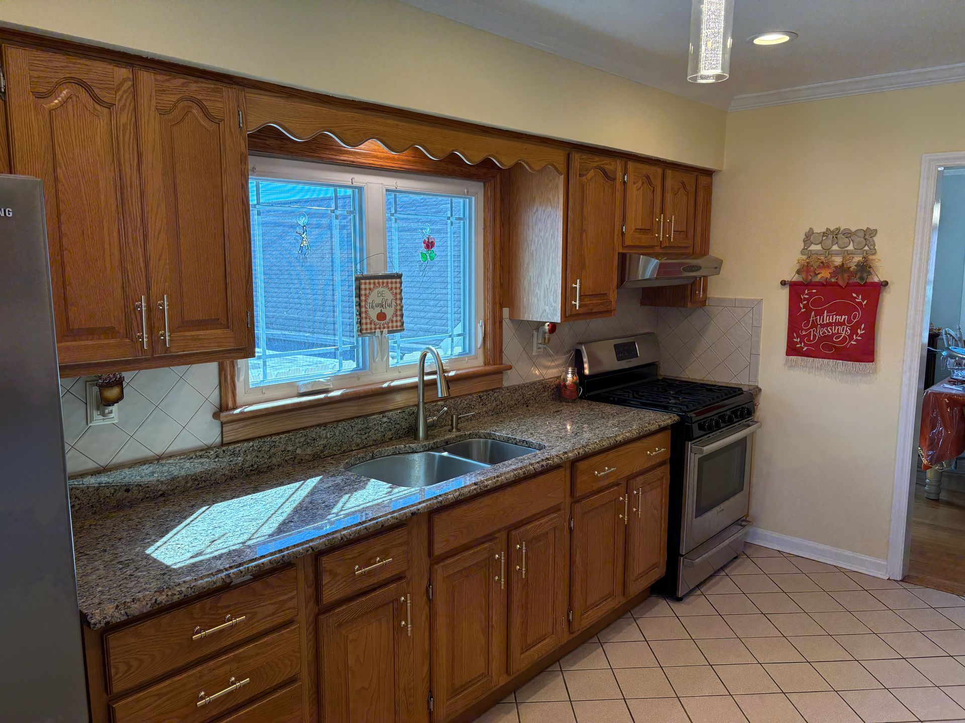 Kitchen with wooden cabinets, granite countertops, and stainless steel appliances.
