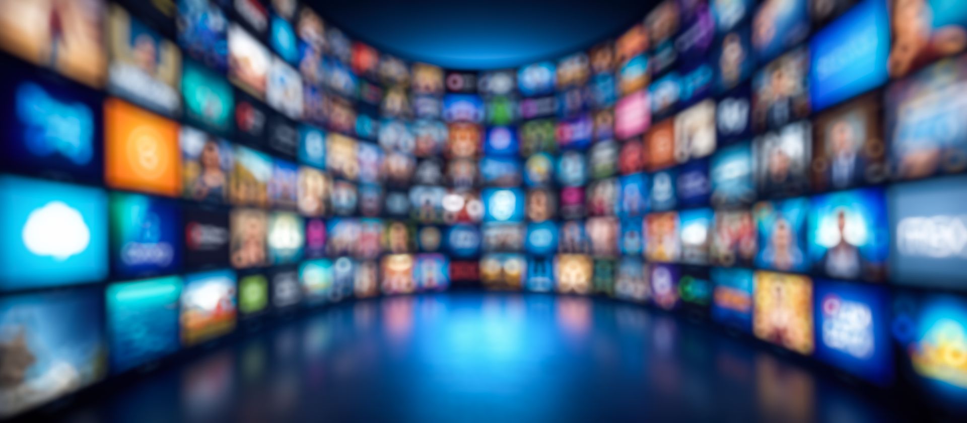 A blurred image of a room filled with lots of television screens.