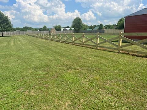 A wooden fence surrounds a lush green field. Clarksville, TN