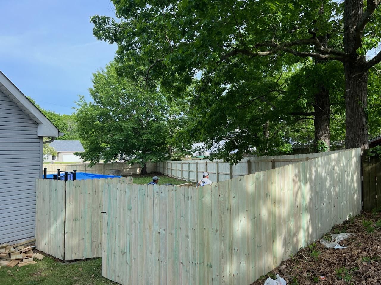 A wooden fence is being built in the backyard of a house. Clarksville,TN