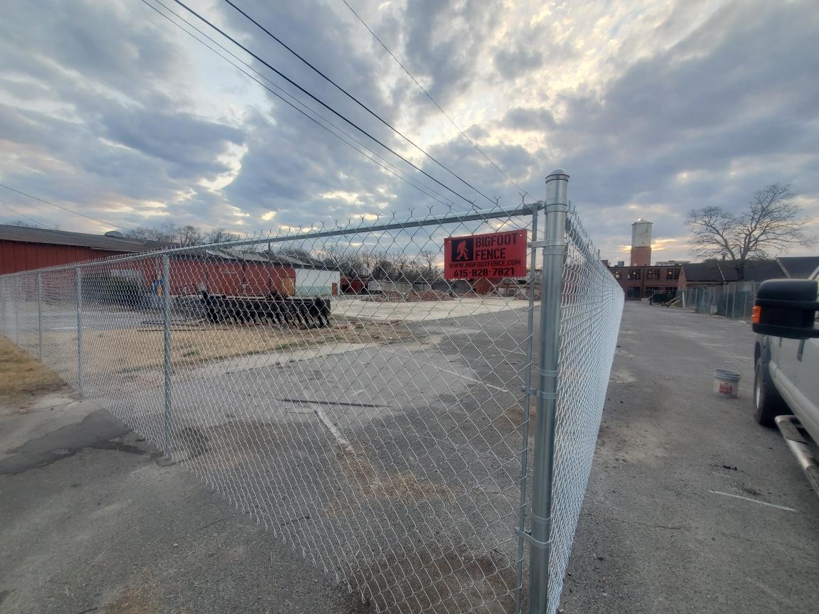 A chain link fence is surrounding a parking lot. Middle, TN