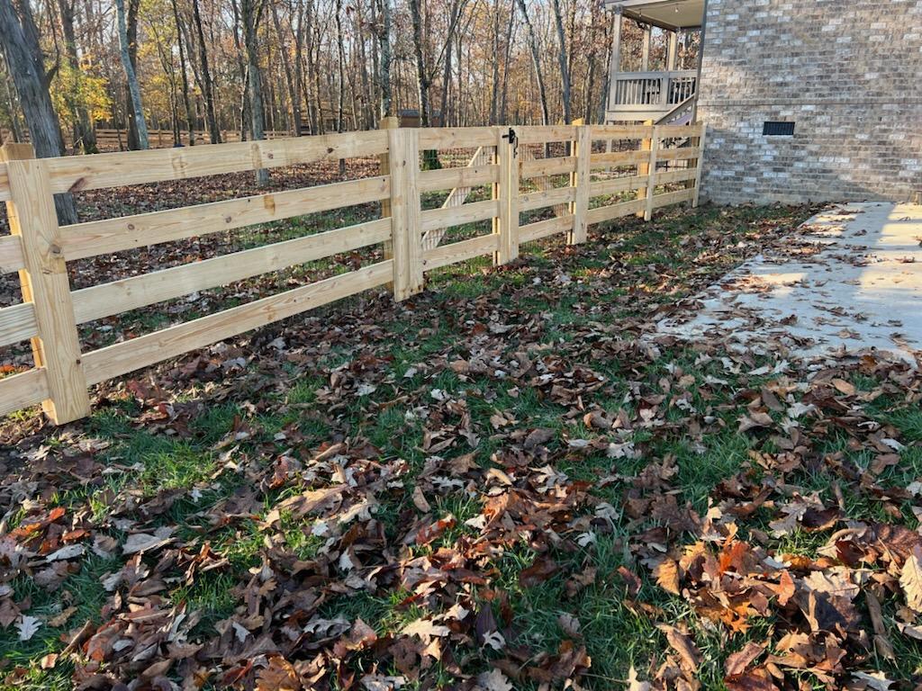 A wooden fence is in the backyard of a house. Middle, TN