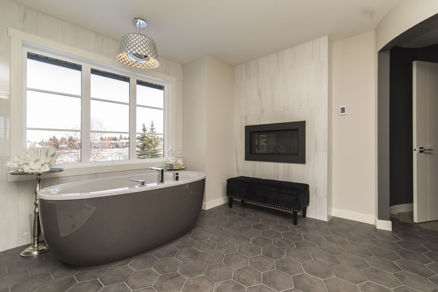 A bathroom with a bathtub and a fireplace.