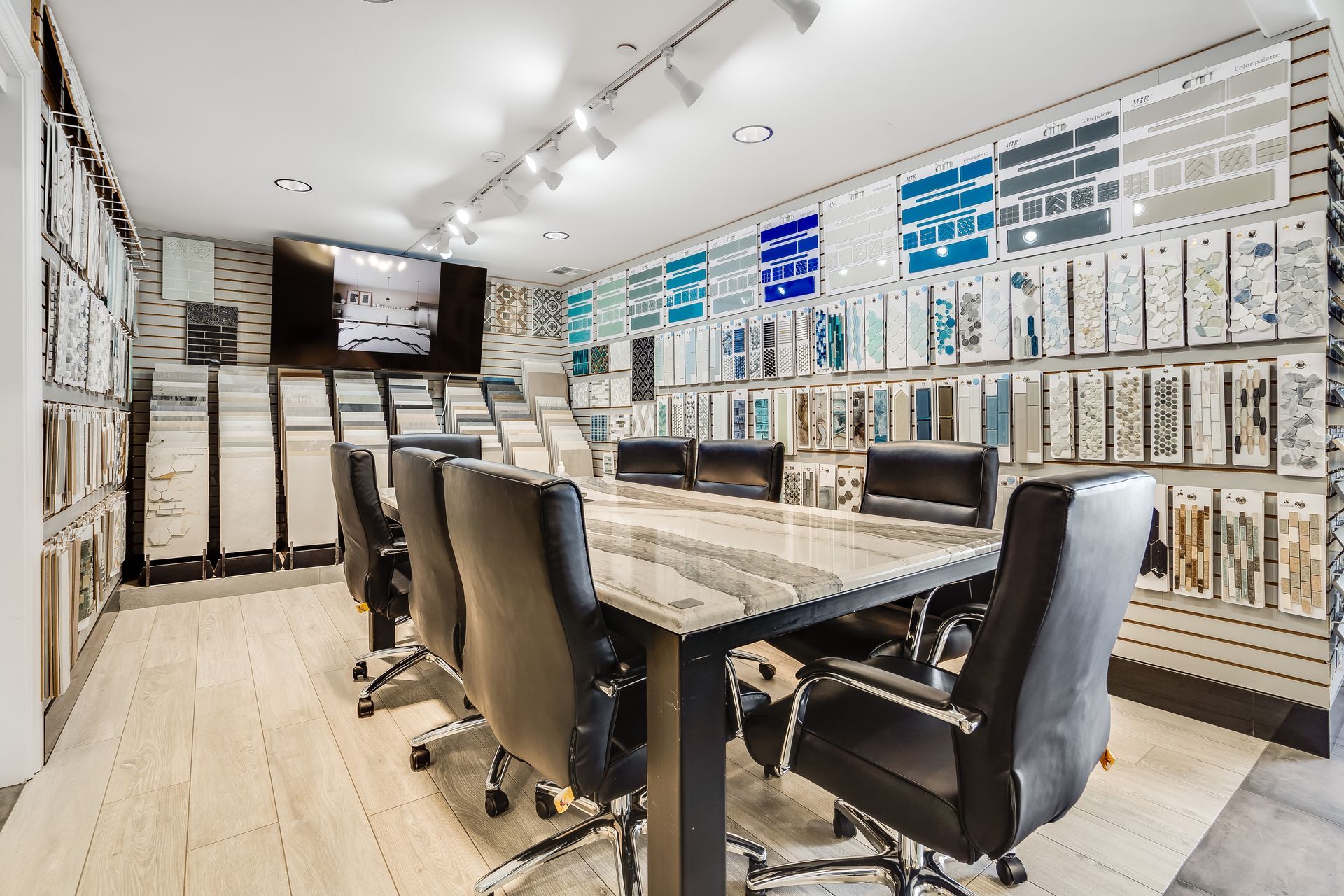 A conference room with a long table and chairs in a store.