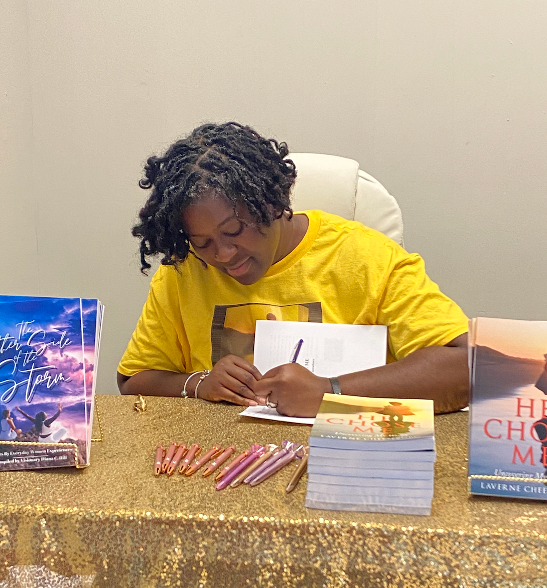 A woman in a yellow shirt is writing on a piece of paper