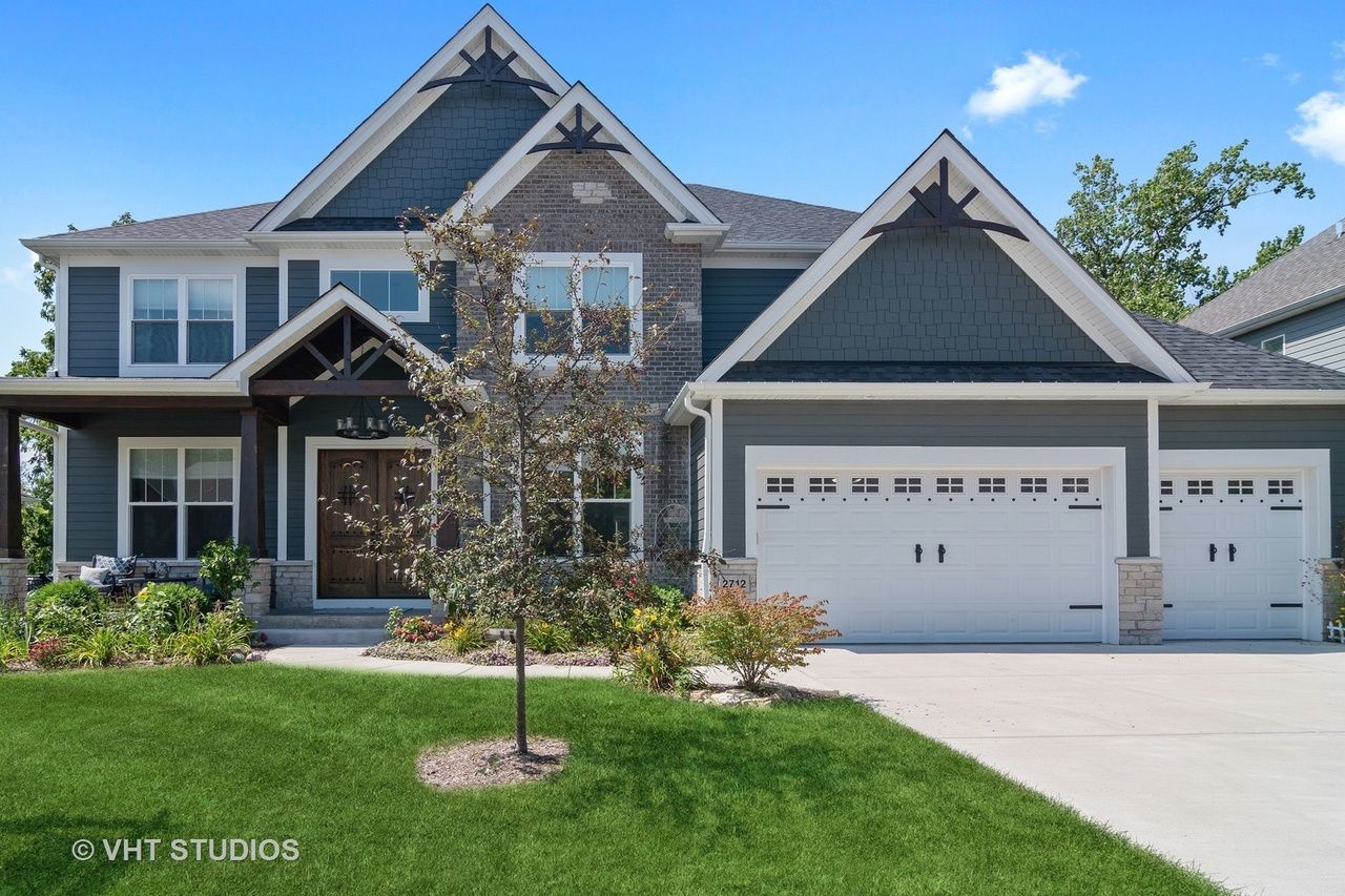 A large house with a lot of windows and a tree in front of it