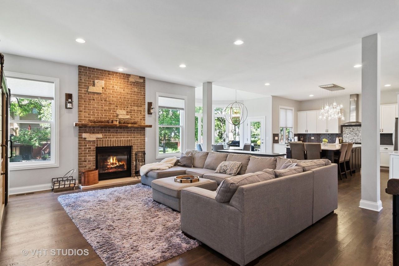 A living room with a couch , fireplace and rug.