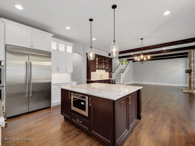 There is a large island in the middle of the kitchen.