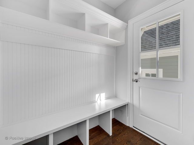 A white bench in a room next to a door