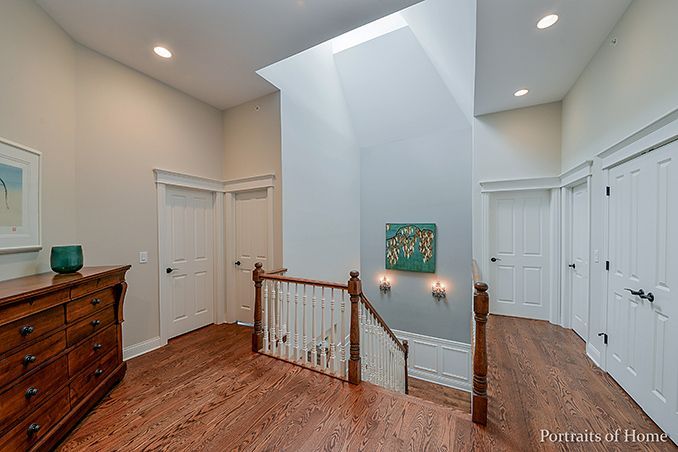 A hallway with stairs leading up to the second floor of a house.
