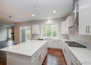 There is a large island in the middle of the kitchen.