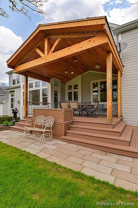 A large wooden porch with stairs leading up to it.