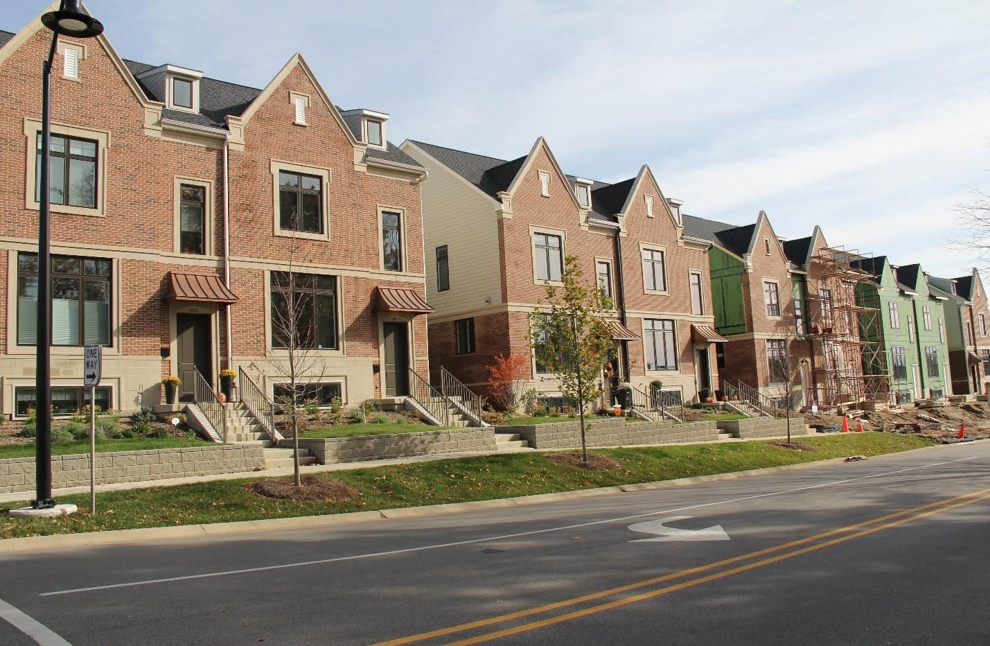 A row of brick houses on the side of a road