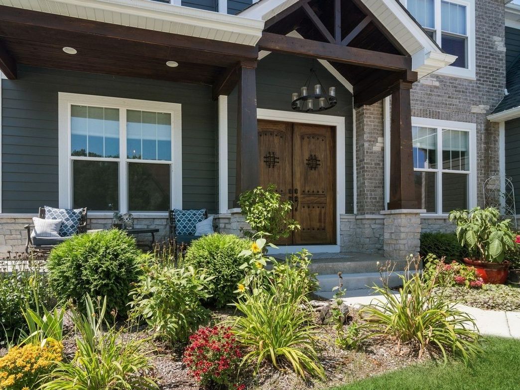 A large house with a porch and a lot of windows