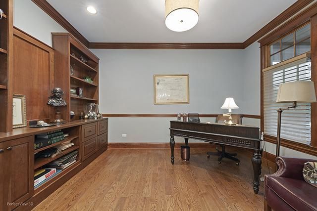 A home office with a desk and a lamp