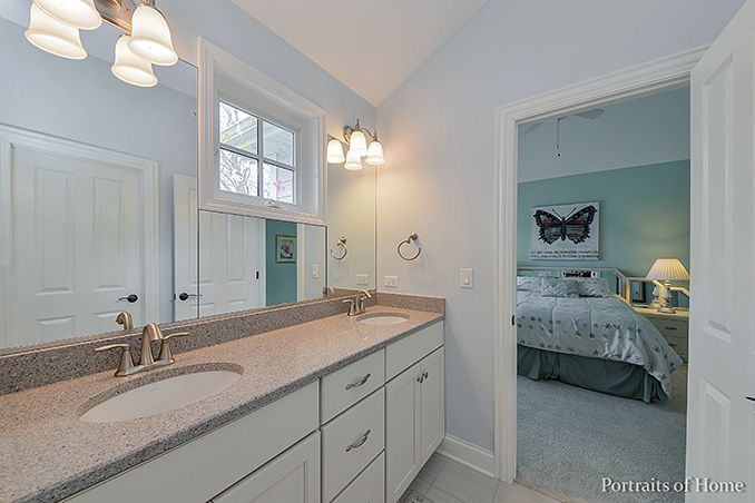 A bathroom with two sinks and a large mirror.
