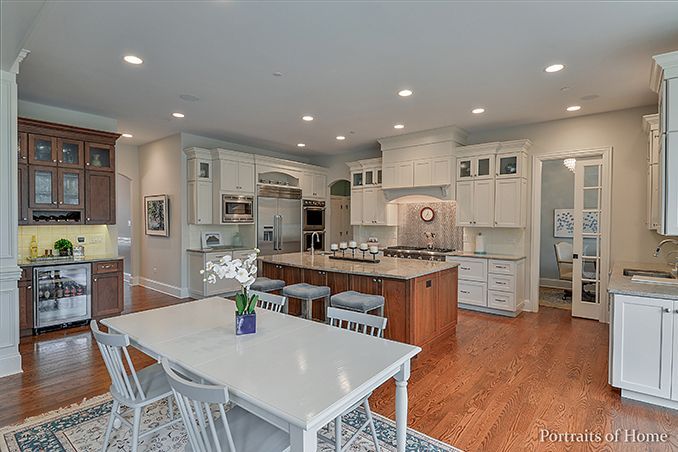 A kitchen with a table and chairs in it