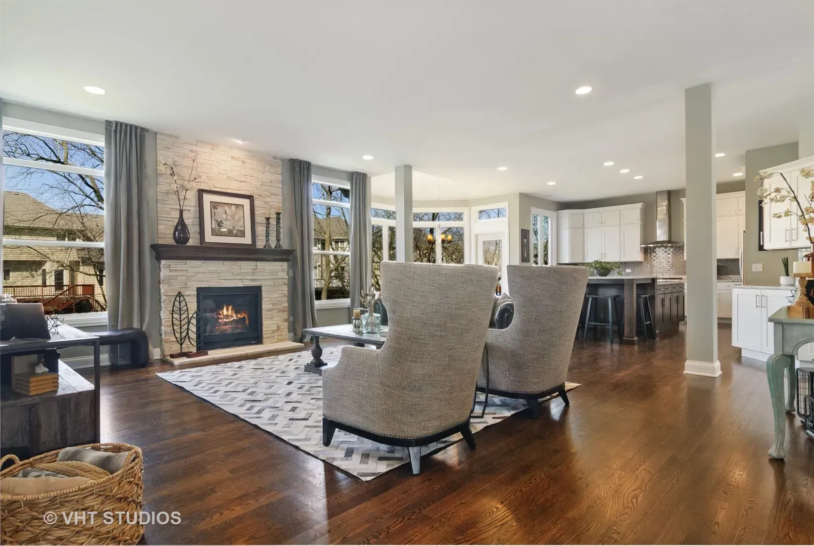 A living room with a fireplace and two chairs