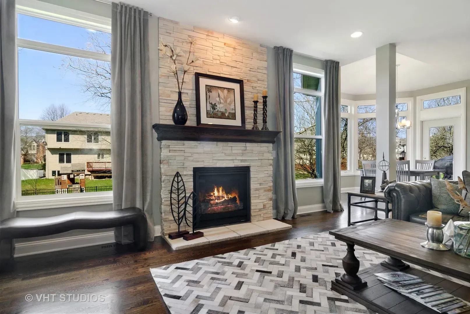 There is a fireplace in the middle of the living room.