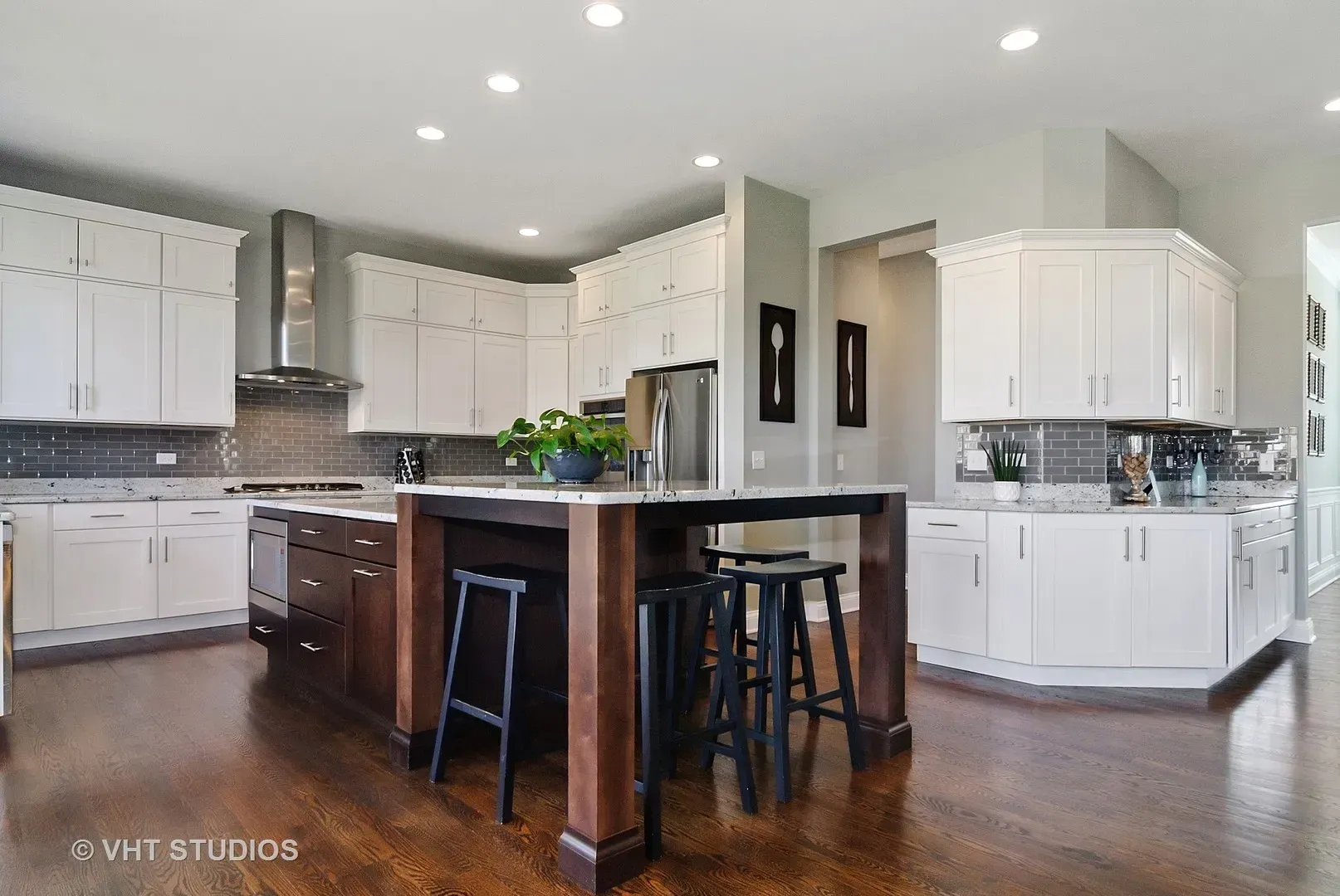 A kitchen with white cabinets and a large island