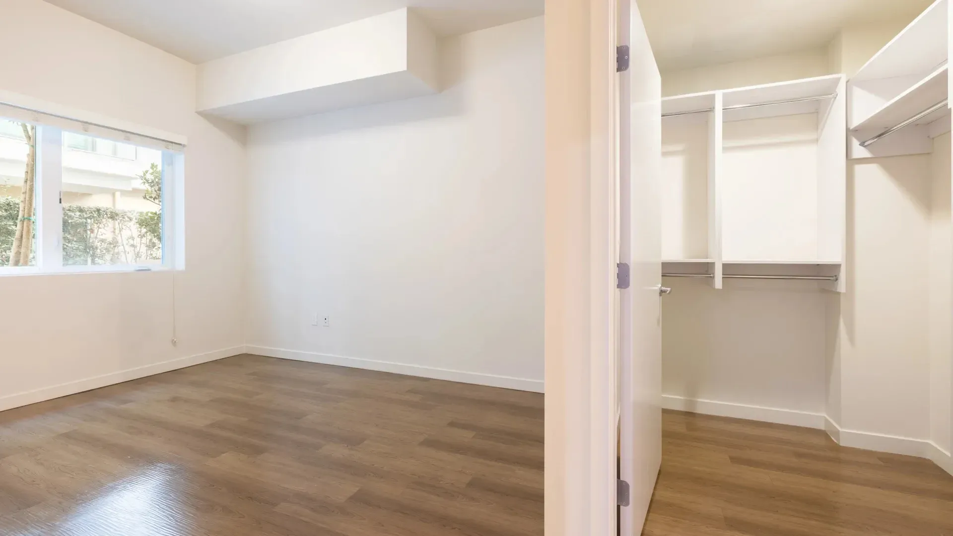 Empty bedroom with large closet at Next on Sixth Los Angeles
