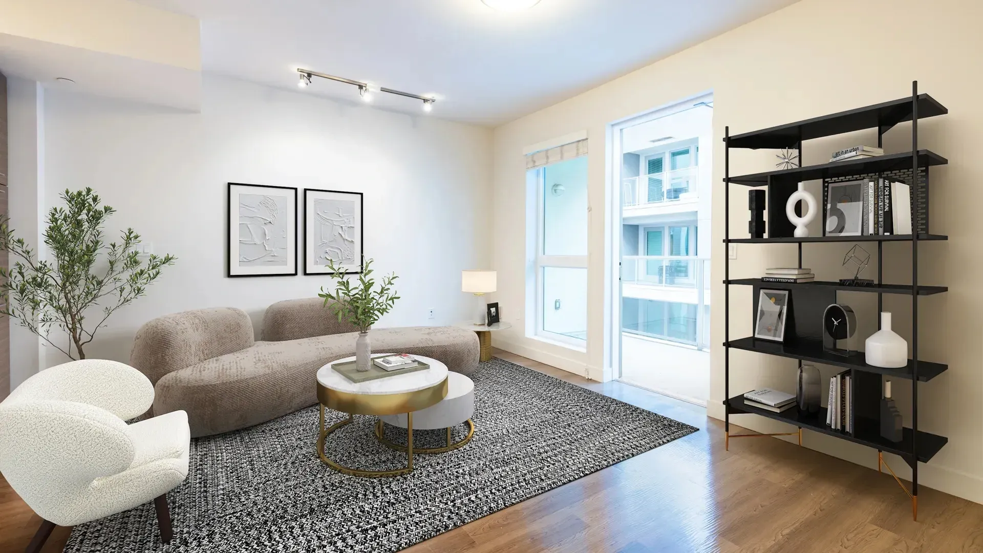 Modern living room with a curved sofa, accent chair, and a black shelving unit at Next on Sixth Los Angeles