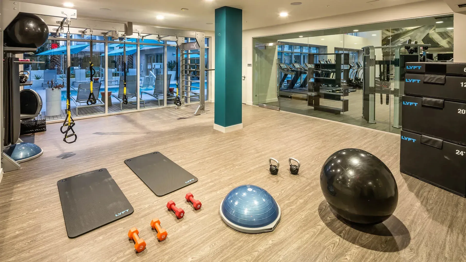 Gym with fitness equipment and view of the pool at Next on Sixth Los Angeles