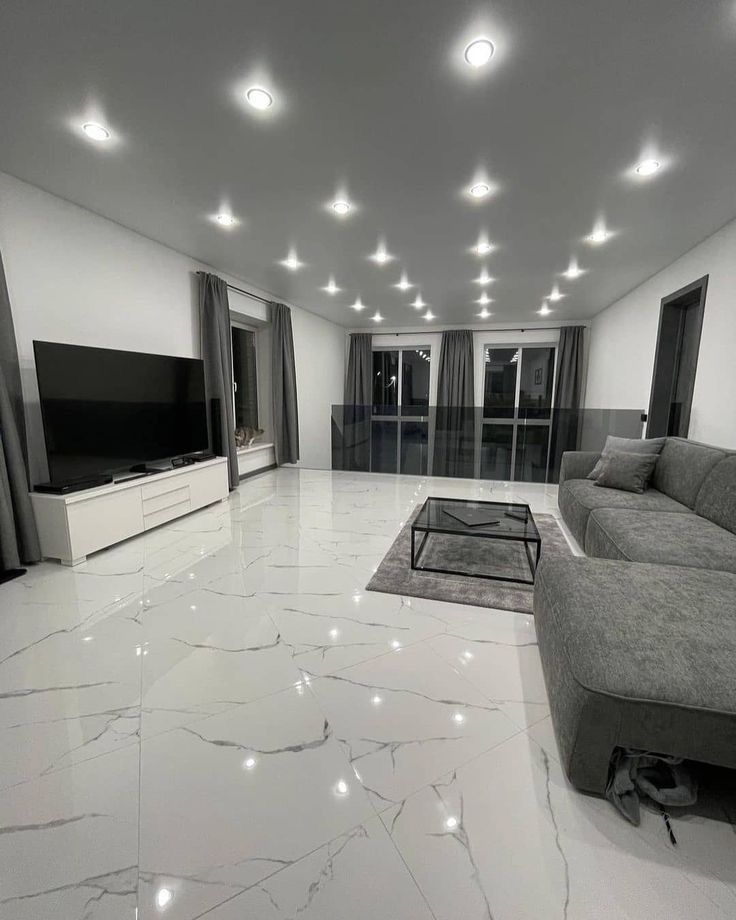 A living room with a couch , television , and coffee table.